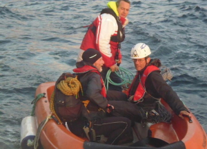 Rob Woodall and Pete Ellis rejoin boatman Seumas Morrison below Stac  Lee (photo: Mark Smith)                                                                                                                                                                                                      